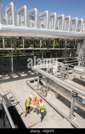 High angle view of engineer with his colleagues in meeting with laptop at geothermal power station, Bavaria, Germany Stock Photo