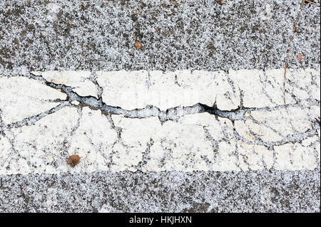 Crack on asphalt under snow in winter Stock Photo