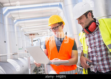 Engineer and worker in meeting with laptop at geothermal power station, Bavaria, Germany Stock Photo