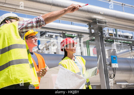 Engineer and workers in meeting on the area of a geothermal energy power station, Bavaria, Germany Stock Photo