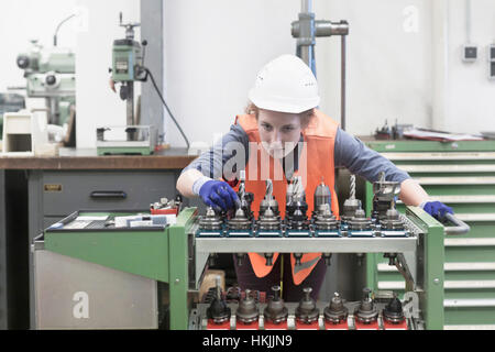 Young female engineer working in an industrial plant, Freiburg im Breisgau, Baden-Württemberg, Germany Stock Photo