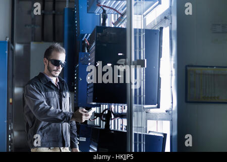 Young male engineer working in technology space, Freiburg Im Breisgau, Baden-Württemberg, Germany Stock Photo