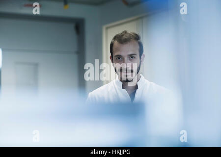 Portrait of a young male scientist working in technology space, Freiburg Im Breisgau, Baden-Württemberg, Germany Stock Photo