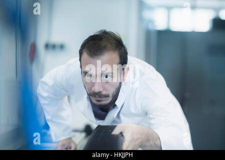 Young male scientist working in technology space, Freiburg Im Breisgau, Baden-Württemberg, Germany Stock Photo