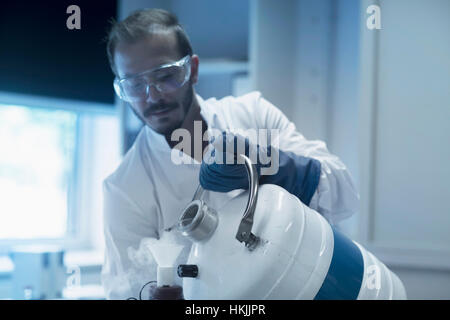 Young male scientist working in laboratory, Freiburg Im Breisgau, Baden-Württemberg, Germany Stock Photo