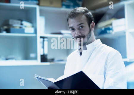 Young male scientist working in technology space, Freiburg Im Breisgau, Baden-Württemberg, Germany Stock Photo