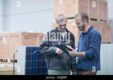 Store workers working in a distribution warehouse, Freiburg im Breisgau, Baden-Württemberg, Germany Stock Photo