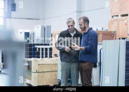Store workers working in a distribution warehouse, Freiburg im Breisgau, Baden-Württemberg, Germany Stock Photo
