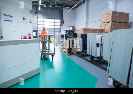 Store workers working in a distribution warehouse, Freiburg im Breisgau, Baden-Württemberg, Germany Stock Photo
