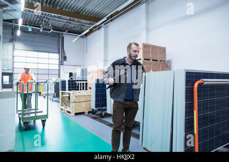 Store workers working in a distribution warehouse, Freiburg im Breisgau, Baden-Württemberg, Germany Stock Photo