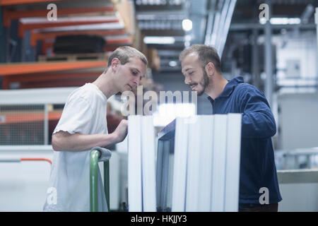 Store workers working in a distribution warehouse, Freiburg im Breisgau, Baden-Württemberg, Germany Stock Photo