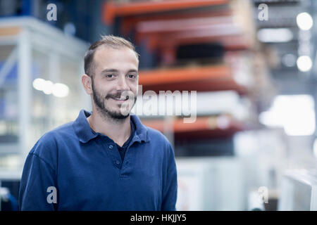 Confident store worker in warehouse, Freiburg im Breisgau, Baden-Württemberg, Germany Stock Photo