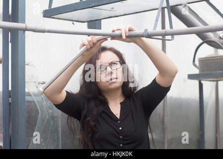 Young woman working in a garden,Freiburg im Breisgau,Baden-Württemberg,Germany Stock Photo