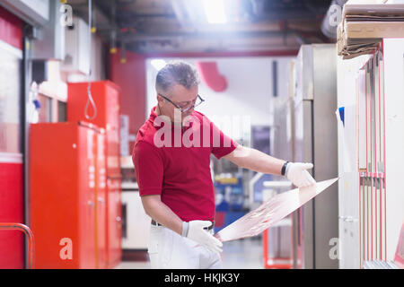 Male engineer examining circuit board in industry,Hanover,Lower Saxony,Germany Stock Photo