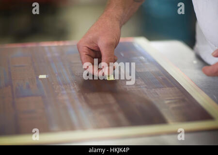 Close-up of human hand examining circuit board in industry,Hanover,Lower Saxony,Germany Stock Photo