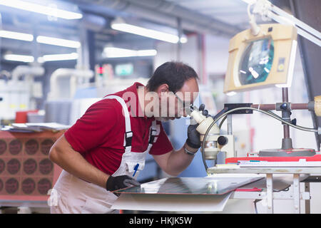 Male engineer examining circuit board in industry,Hanover,Lower Saxony,Germany Stock Photo