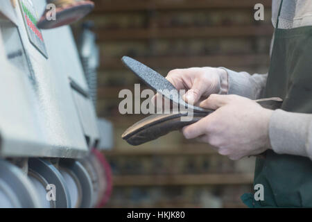 Shoemaker repairing shoe in a workshop, Freiburg im Breisgau, Baden-Württemberg, Germany Stock Photo