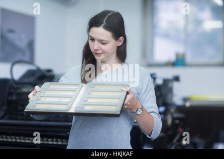 Print worker examining printing plate in an industry, Freiburg im Breisgau, Baden-Württemberg, Germany Stock Photo