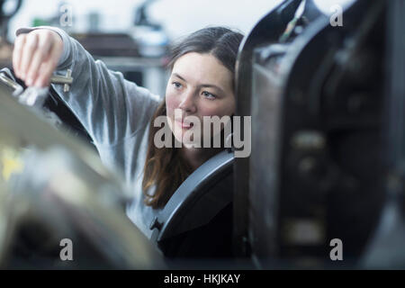 Print worker adjusting printing machine in an industry, Freiburg im Breisgau, Baden-Württemberg, Germany Stock Photo
