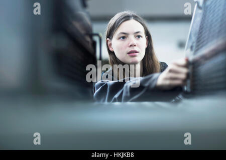 Print worker adjusting printing machine in an industry, Freiburg im Breisgau, Baden-Württemberg, Germany Stock Photo