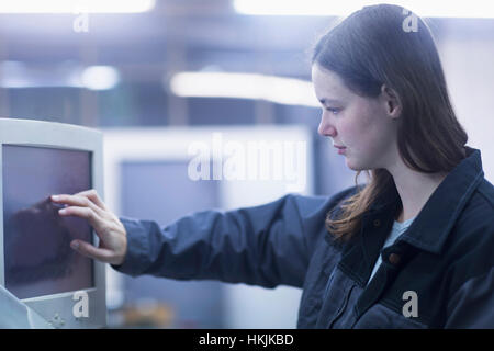 Print worker working at computer in an industry, Freiburg im Breisgau, Baden-Württemberg, Germany Stock Photo