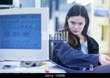 Print worker working at computer in an industry, Freiburg im Breisgau, Baden-Württemberg, Germany Stock Photo