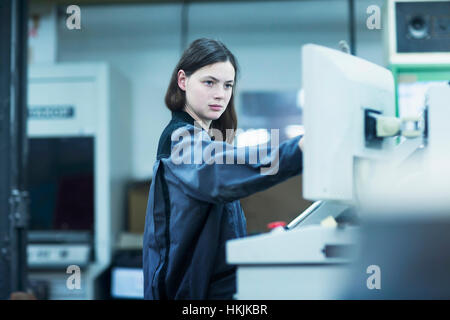 Print worker working in an industry, Freiburg im Breisgau, Baden-Württemberg, Germany Stock Photo