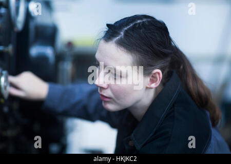 Print worker adjusting printing machine in an industry, Freiburg im Breisgau, Baden-Württemberg, Germany Stock Photo