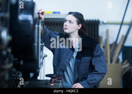 Print worker adjusting printing machine in an industry, Freiburg im Breisgau, Baden-Württemberg, Germany Stock Photo