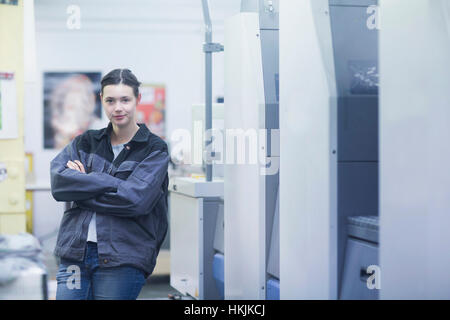Portrait of a print worker standing with her arms crossed, Freiburg im Breisgau, Baden-Württemberg, Germany Stock Photo
