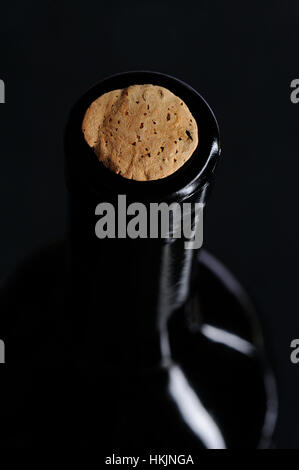 close up of cork on wine bottle on black Stock Photo