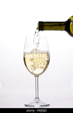 pouring white wine with drops and sparkle from bottle Stock Photo