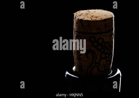 close up of wine cork in bottle on black background