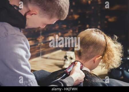 Little Boy Getting Haircut By Barber Stock Photo