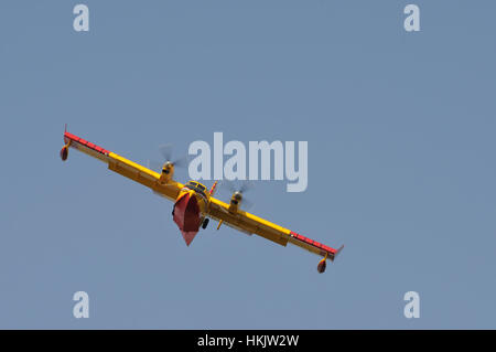 Canadair aircraft water bomber, turbo prop firefighting aircraft in action, shot from front and below, shot from forward below, aircraft in right bank Stock Photo