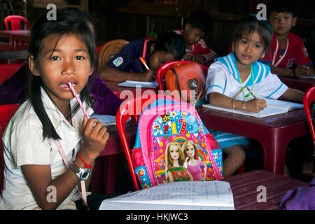 A 10 year old Asian girl is thinkng an English language school in Chok Village,  Tboung Khmum Province, Cambodia. Stock Photo