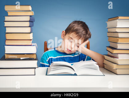 seven years old child reading a book Stock Photo