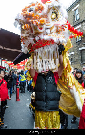 London, UK. 28th January, 2017. A chinese dragon parades around Chinatown in London and blesses shops and restaurants. Credit: Matthew Ashmore/Alamy Live News Stock Photo