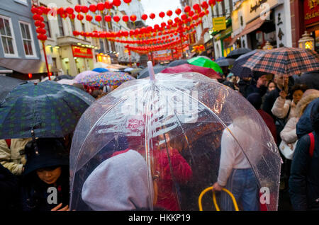 London, UK. 29th Jan, 2017. Large crowds brave the cold and rain to join in on the Chinese New Year celebrations in Chinatown, Soho, London. Stock Photo