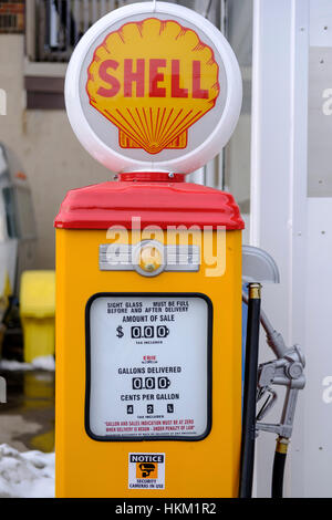 Vintage yellow decommissioned fuel pump with Shell logo in front of a service station in London, Ontario, Canada. Stock Photo