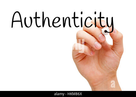 Hand writing Authenticity with black marker on transparent glass board. Stock Photo