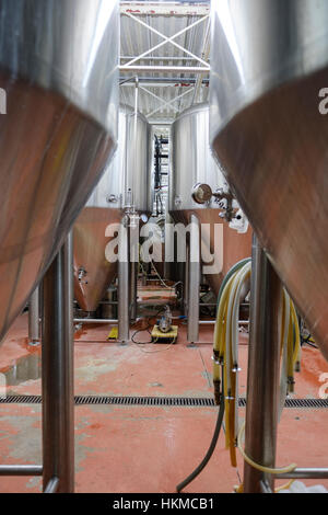 Several stainless steel commercial beer tanks / vats used for fermenting beer at Railway City Brewing Co. in St Thomas, Ontario, Canada. Stock Photo