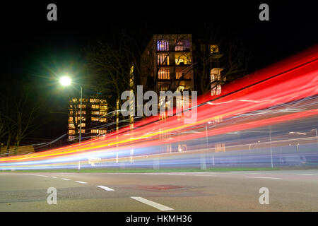 light streaks created by passing cars at an apartment building in the city Stock Photo