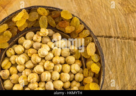 chick peas and  raisins in a big coconut shell Stock Photo