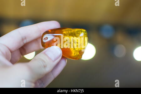 Hand holding an amber stone  in musum Stock Photo