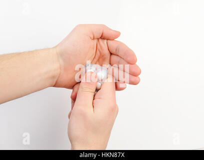 Pack of pill in hand on white background Stock Photo