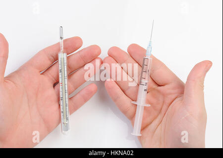thermometer and syringe in hand on white background Stock Photo
