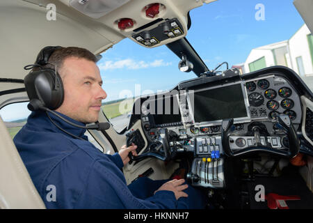 Man in cockpit of aircraft Stock Photo