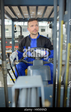 man driving a forklift Stock Photo