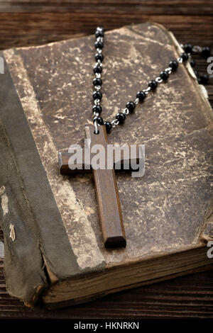 Very old holy bible and wooden cross with empty space for text Stock Photo